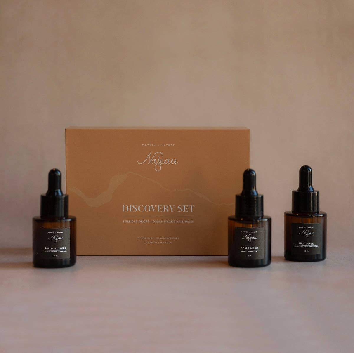 Najeau Haircare discovery set with 3 bottles and a box on a beige background